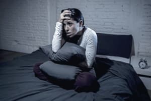 woman in bed up late portraying overdose on meth