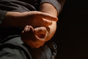 Long-Term Vicodin Effects close up of person injecting vicodin into arm in dark room