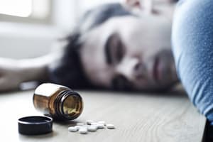 Ativan Overdose Man passed out on ground portraying an Ativan overdose victim