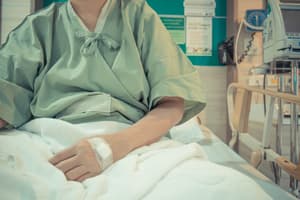 Drugs and Health Problems close-up of man in hospital bed suffering from health problems due to drug use