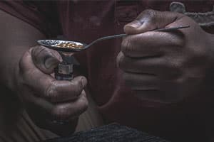 addict heating up heroin spoon