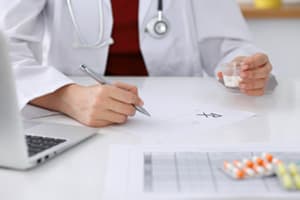 Prescription Medication Treatment close-up of doctor prescribing medication for medication assisted treatment for Norco addiction