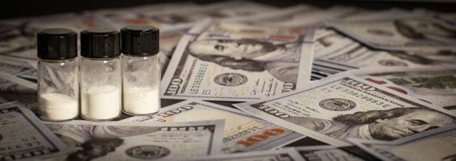 free market solution to the war on drugs pill vial over dollar bills