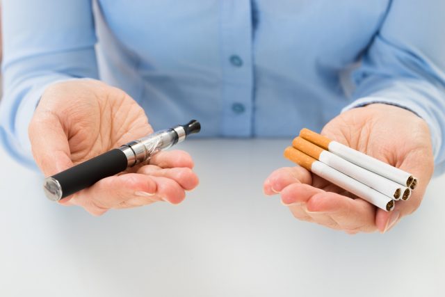 Man offering vaping pen cigarettes