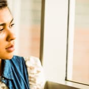 rahabs-shutter243756076-woman-looking-out-of-window