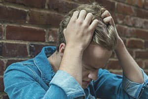 Anxious man pulling on his hair