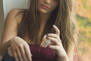 Woman examining prescription bottle of Valium