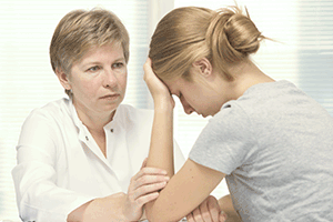 Doctor comforting female patient