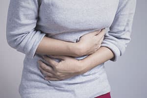 woman holding stomach due to codeine withdrawal
