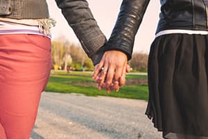 two women holding hands