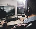 Man sits facing computer game